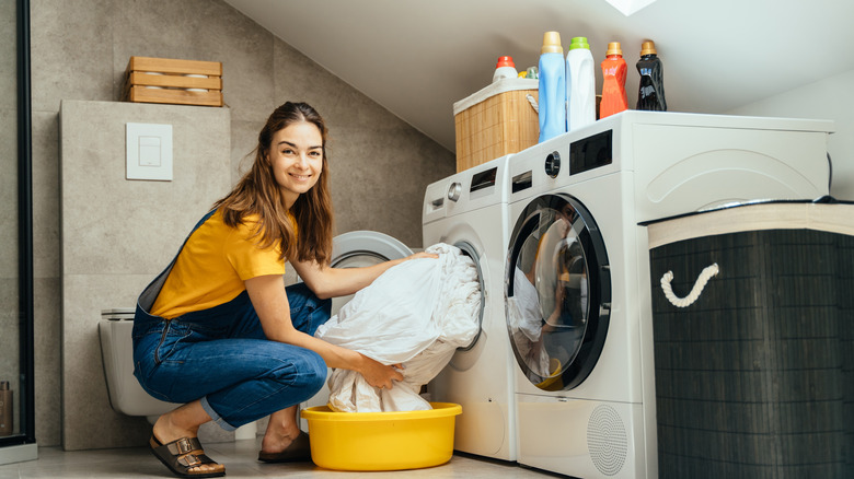 Woman smiling while doing laundry