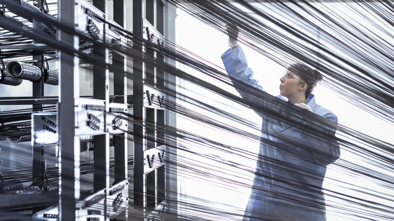 A factory worker processing carbon fiber