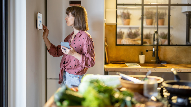 woman using display in kitchen