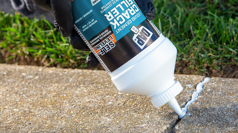 DAP sealant being used to seal a concrete crack
