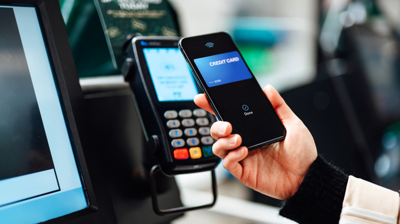 An NFC-powered contactless transaction takes place at a payment terminal.