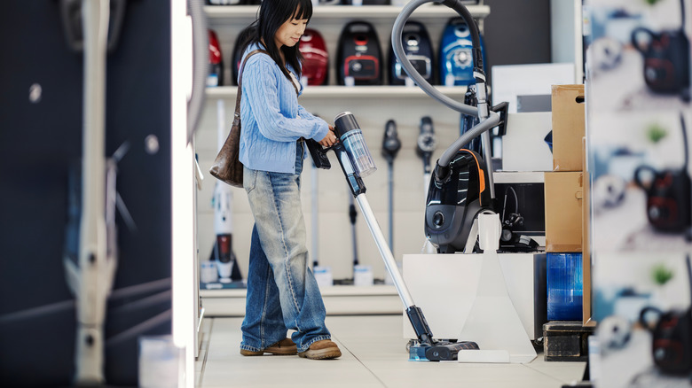 Buyer tries out a vacuum in a store