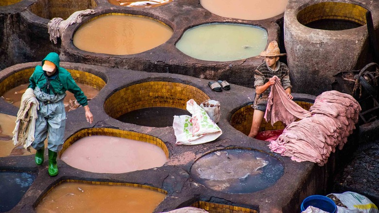 Workers dyeing leather 