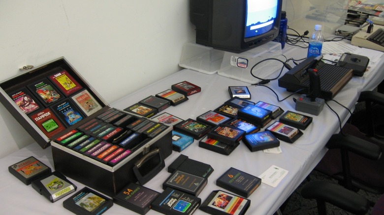 An Atari 2600 with a CRT TV playing "The Empire Strikes Back" with a collection of games