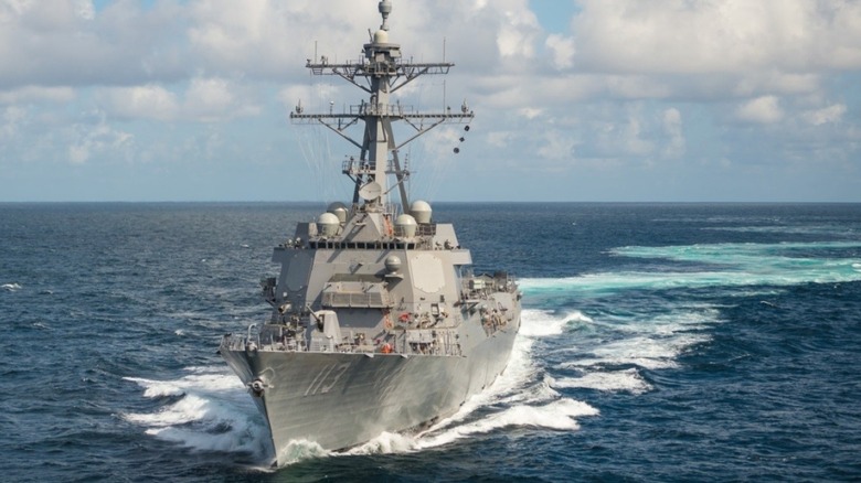 an Arleigh Burke (DDG 51) class guided missile destroyer making way.