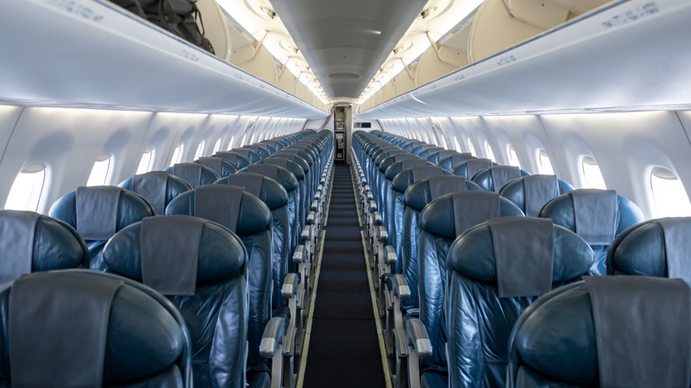 Many rows of empty airline seats.