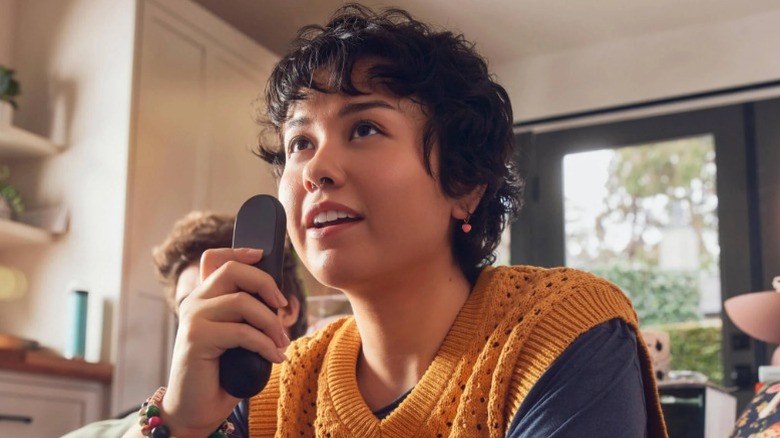 Person holding TV remote