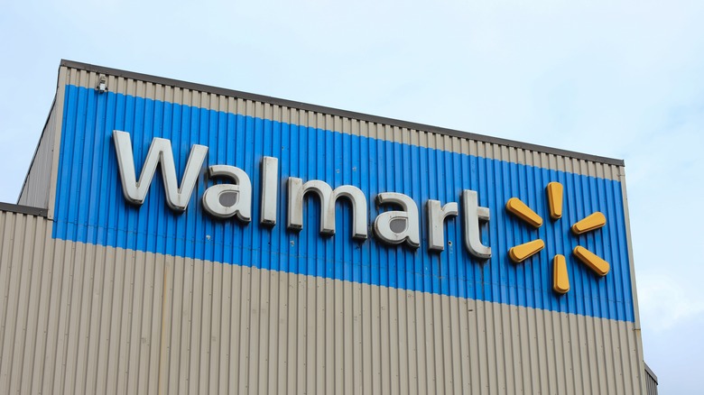 A Walmart sign against a cloudless sky.