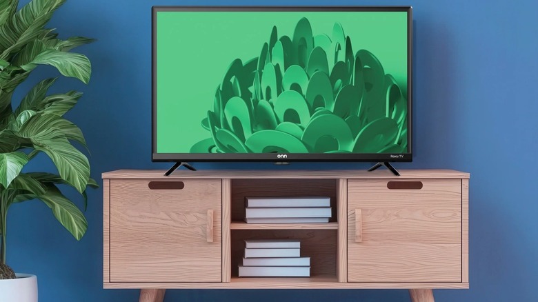 Roku TV sitting on top of a television stand