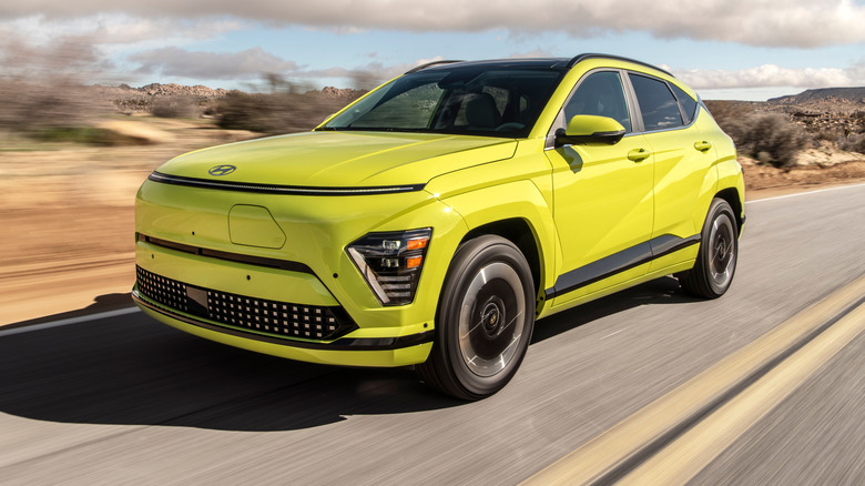 A bright yellow 2025 Hyundai Kona on the road with dessert landscape in the background