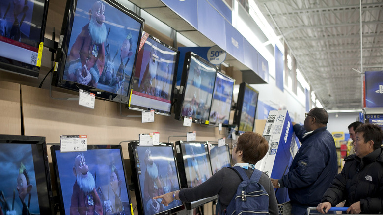 Shoppers look at televisions at Walmart