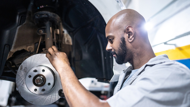 Mechanic tending to brakes