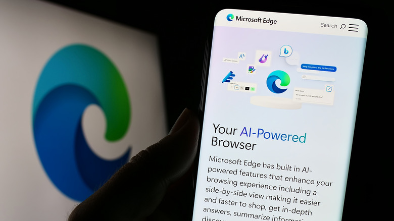 Person holding cellphone with Microsoft Edge on screen
