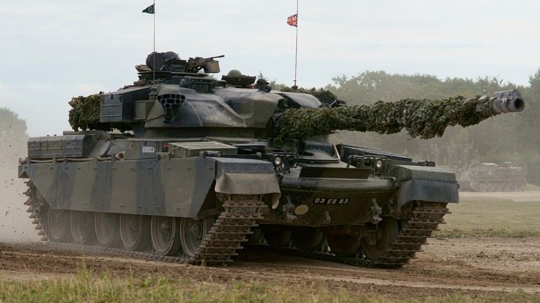 A Chieftain Mark 11 Main Battle Tank driving on a dirt road