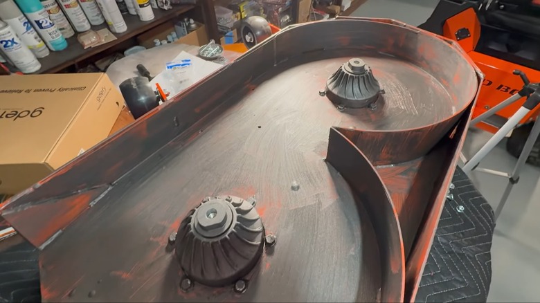 A lawn mower deck covered in Slip Plate.