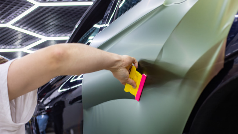 A person wrapping a vehicle.