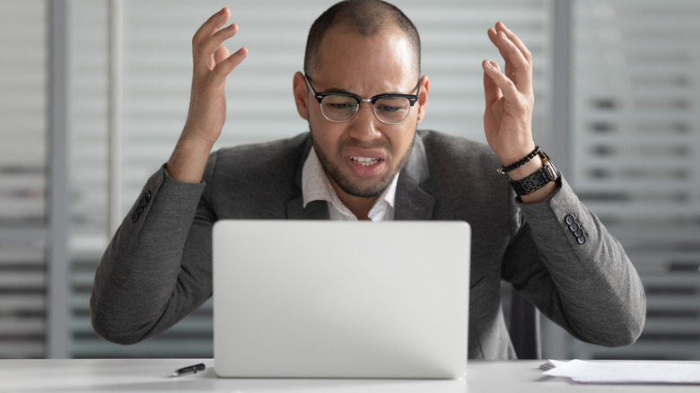 Angry person staring at laptop