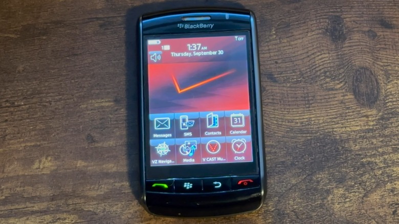 A BlackBerry Storm on a wood table.