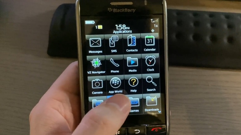 A person holding a BlackBerry Storm.