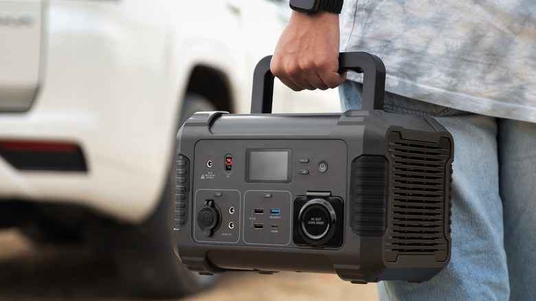 A man carrying a portable power station by handle