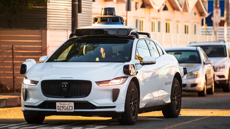 Front view of a Waymo car at traffic light