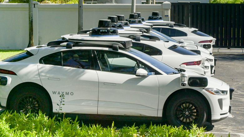 Waymo cars in a parking lot.