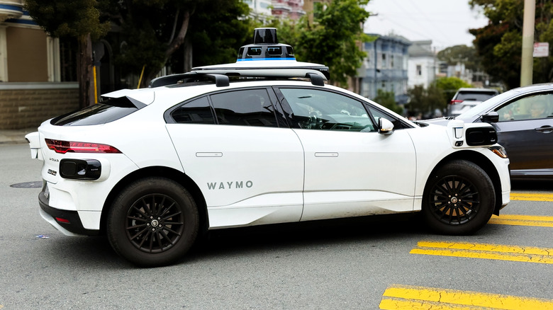 Waymo driverless electric vehicle navigating intersection