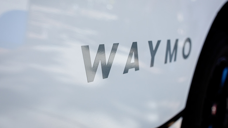 Waymo logo on a car's side door