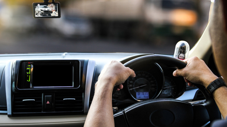 A driver is using their smartphone as a dash cam