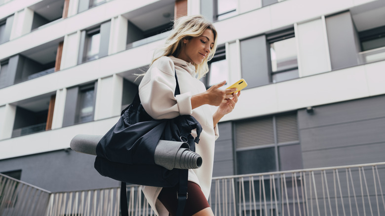 woman with phone workout gear