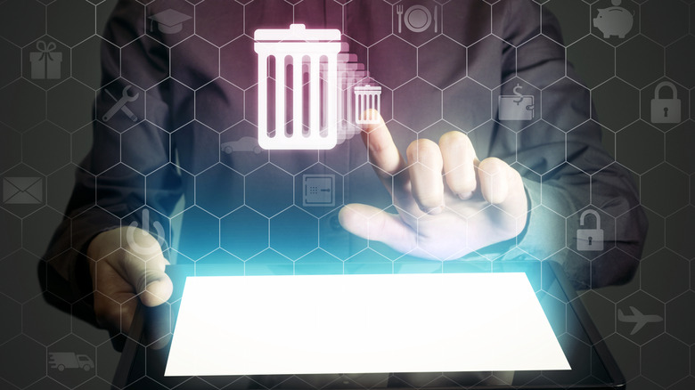 trash icons above a glowing tablet