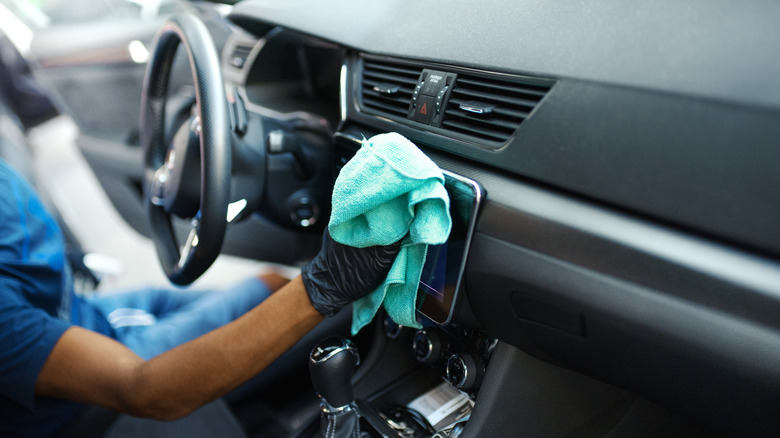 Man detailing interior of vehicle