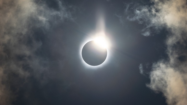 Solar eclipse in a cloudy sky