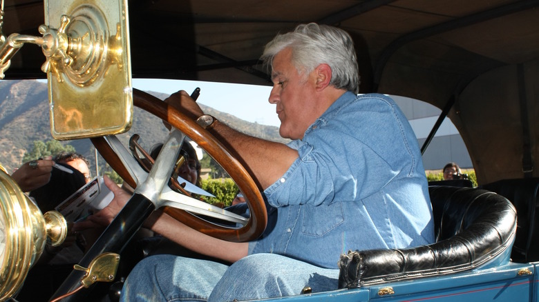 Jay Leno signing autographs in car