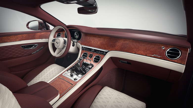 An interior view of a dual-tone luxurious Bentley, its infotainment display concealed