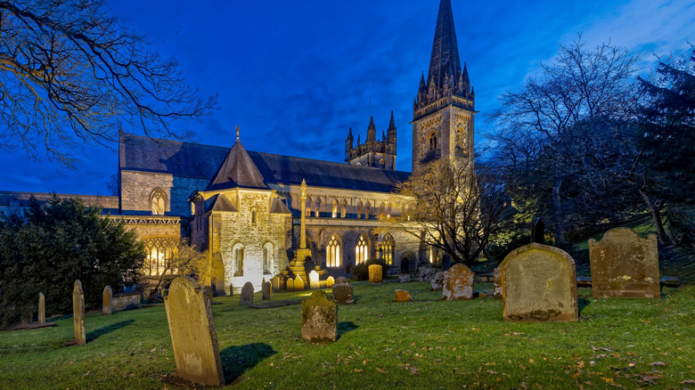 church in cemetery among gravestones