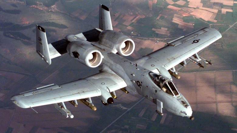 An A-10A flies above farmland