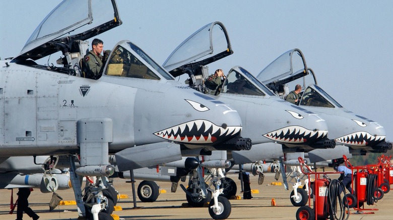 Pilots settling in to three A-10s in a line preparing to launch