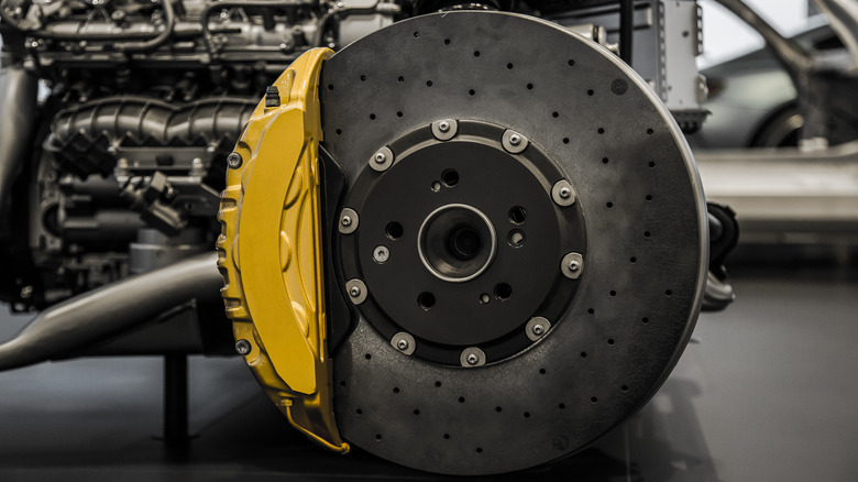 A carbon ceramic brake disc with a yellow caliper