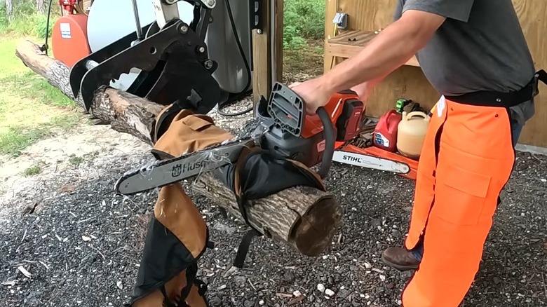 A chainsaw and tangle of threads following contact with chainsaw chaps.