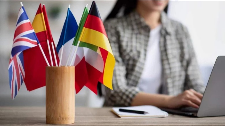 several small flags on a work desk 