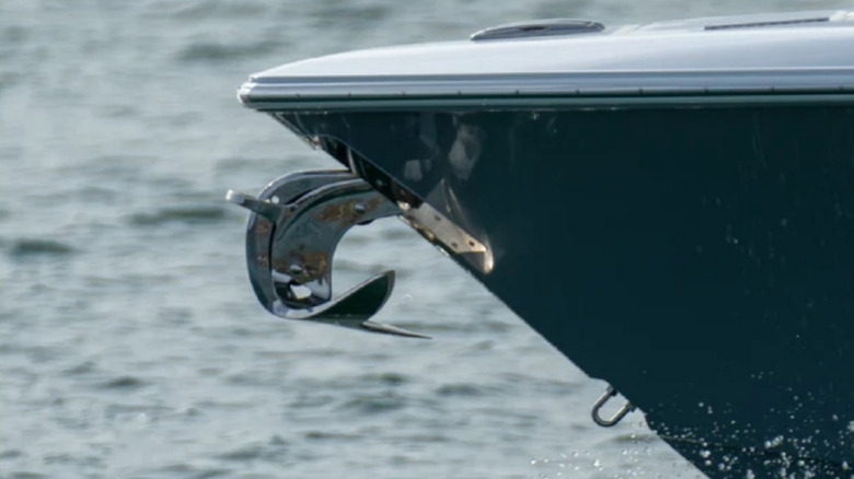 Close-up on a claw anchor mounted on the front of a boat