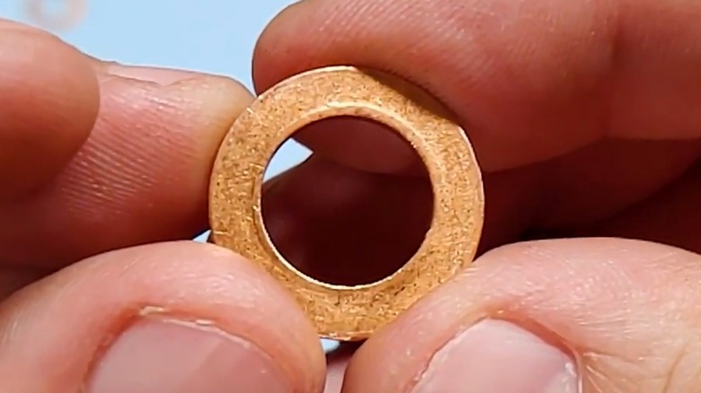 A person holding a used crush washer.