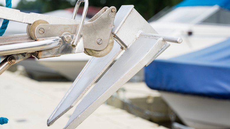 An anchor on a boat lying on the pier side