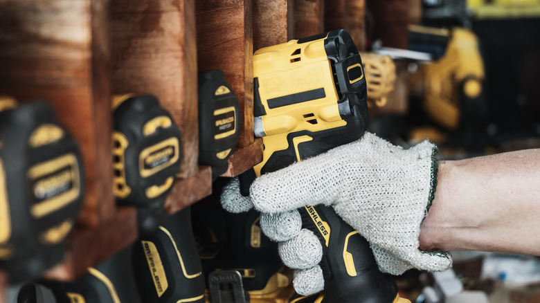 Worker grabbing DeWalt drill