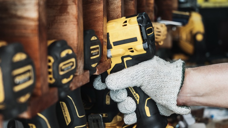 Worker grabbing DeWalt drill