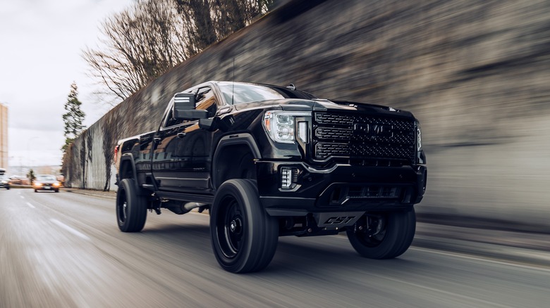 GMC Sierra Denali driving on road