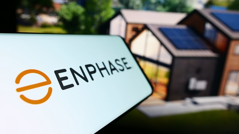 Enphase logo in front of house with solar panels
