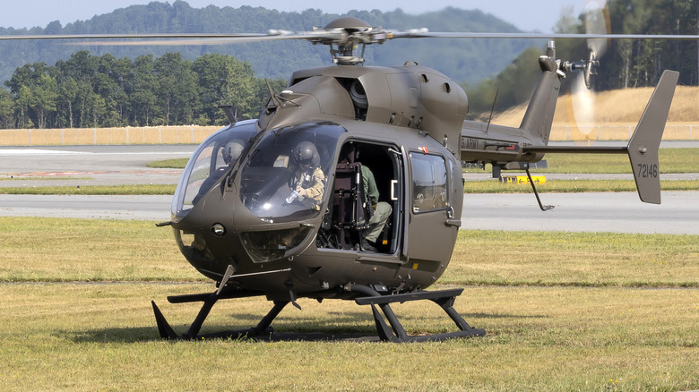 A UH-72 Lakota helicopter parked on grass.