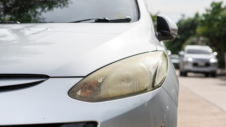 Oxidized headlight of silver car.